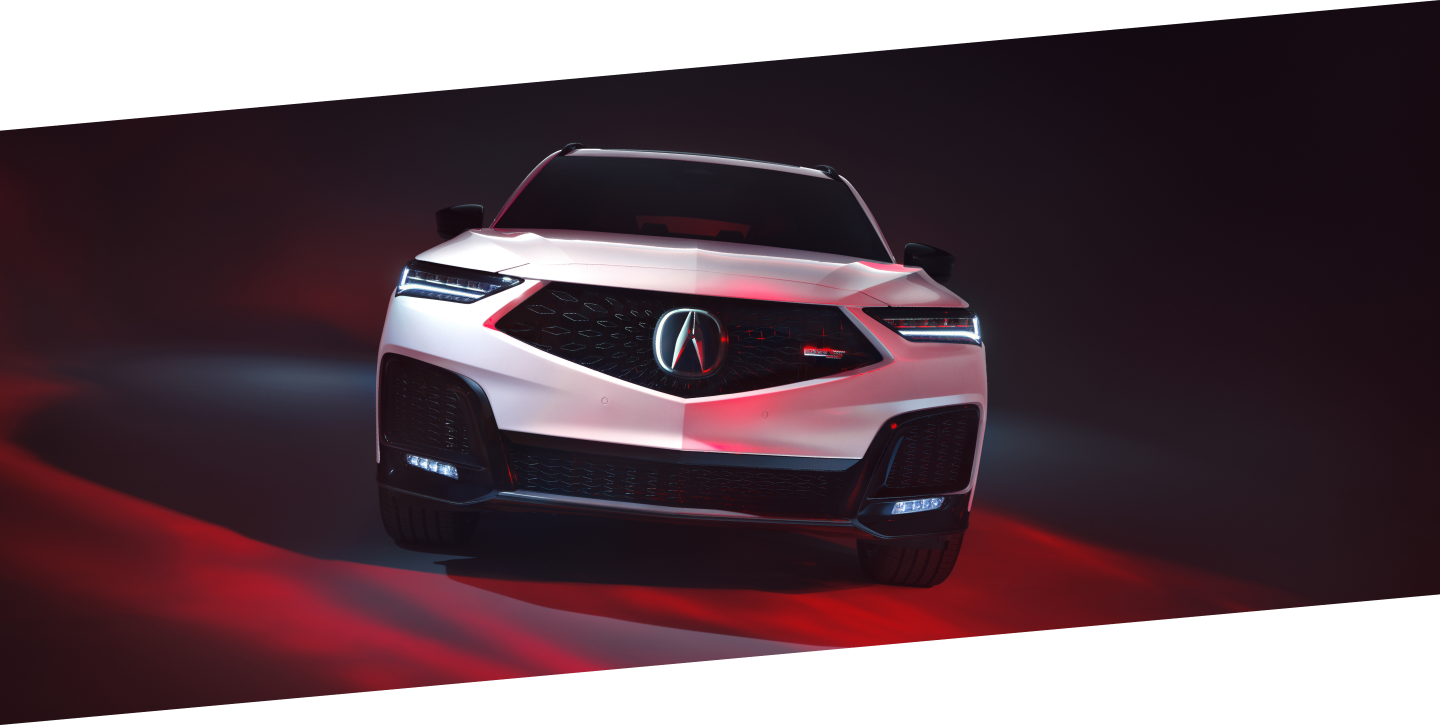 Front view of white MDX Type S Ultra in a studio lit with red light.